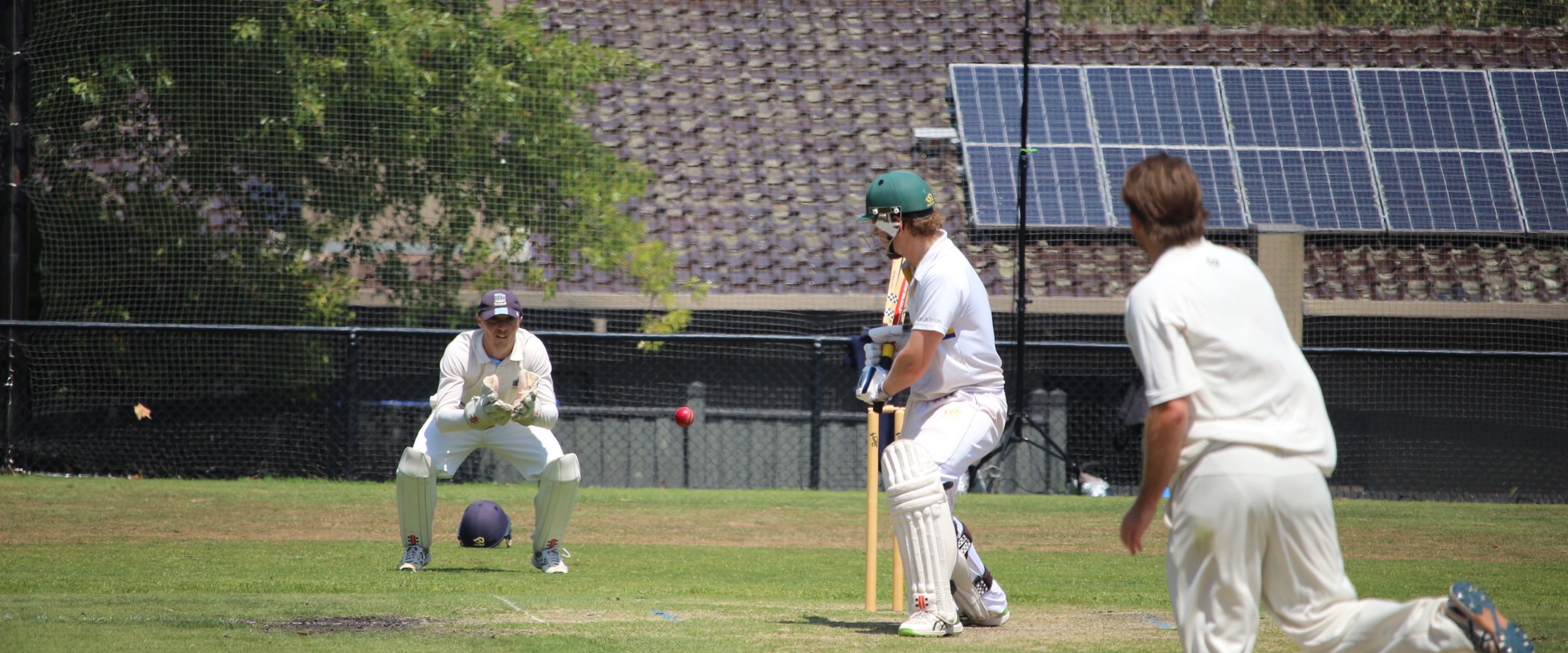 A batter leaves a ball outside off stump on the turf at Canterbury Sports Ground and the Canterbury wicketkeeper takes it behind the stumps
